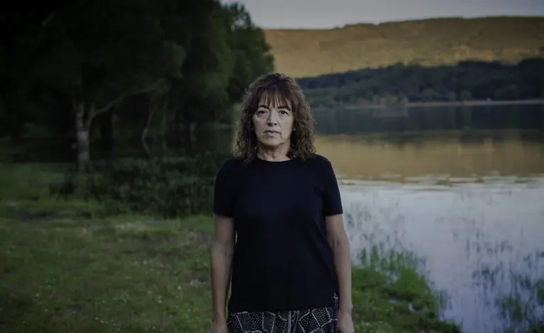 Woman in field near reservoir in Spain